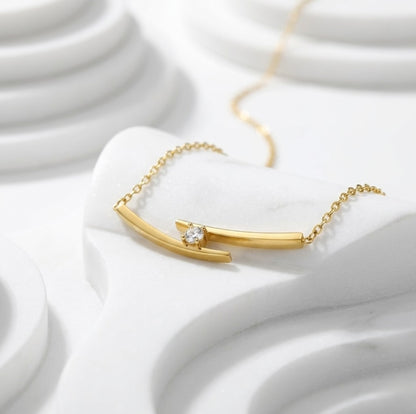 BEHI Alison Necklace displayed on a sculptural white base, emphasizing its architectural form and polished texture.