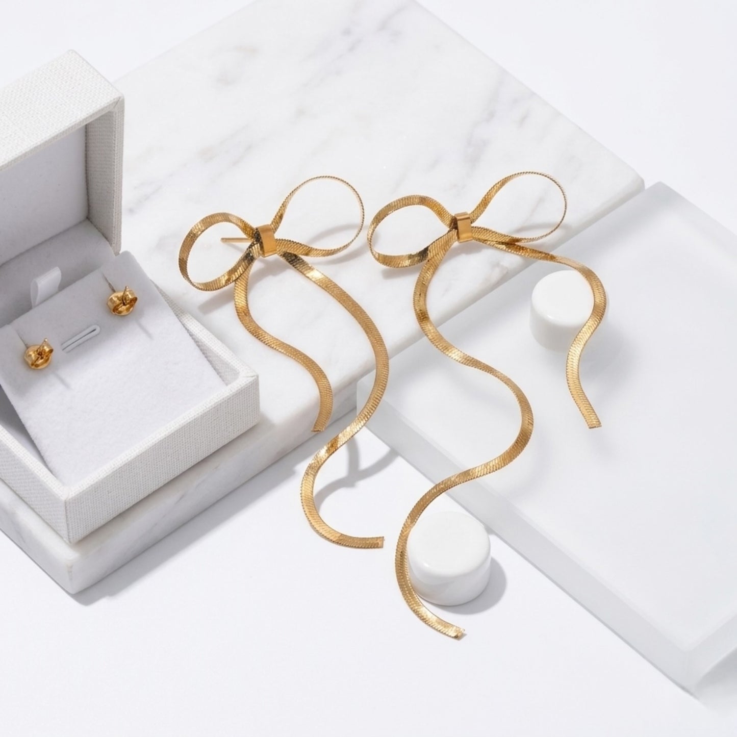 BEHI Lina Earrings displayed on luxury gift boxes, emphasizing their delicate ribbon-like silhouette.