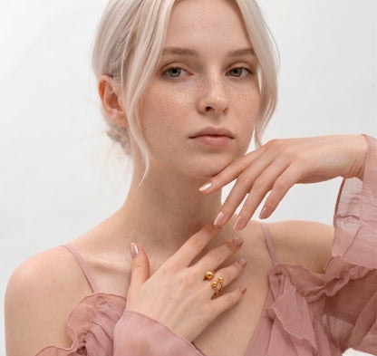 BEHI Mia Bta Ring styled on a model to demonstrate its modern, architectural form and high-polish golden glow.