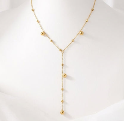 BEHI Rovena Necklace displayed on a white bust, emphasizing the graceful drape of the beaded lariat design.