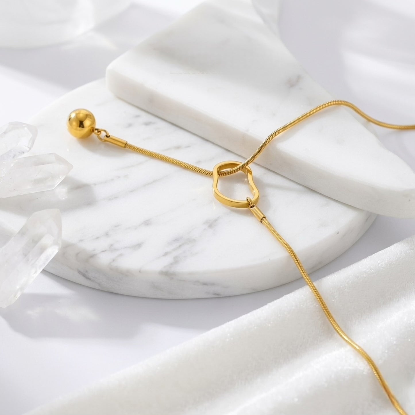 An angled perspective of the BEHI Temwoo Necklace, showcasing the unique oval clasp and high-polish drop pendant.