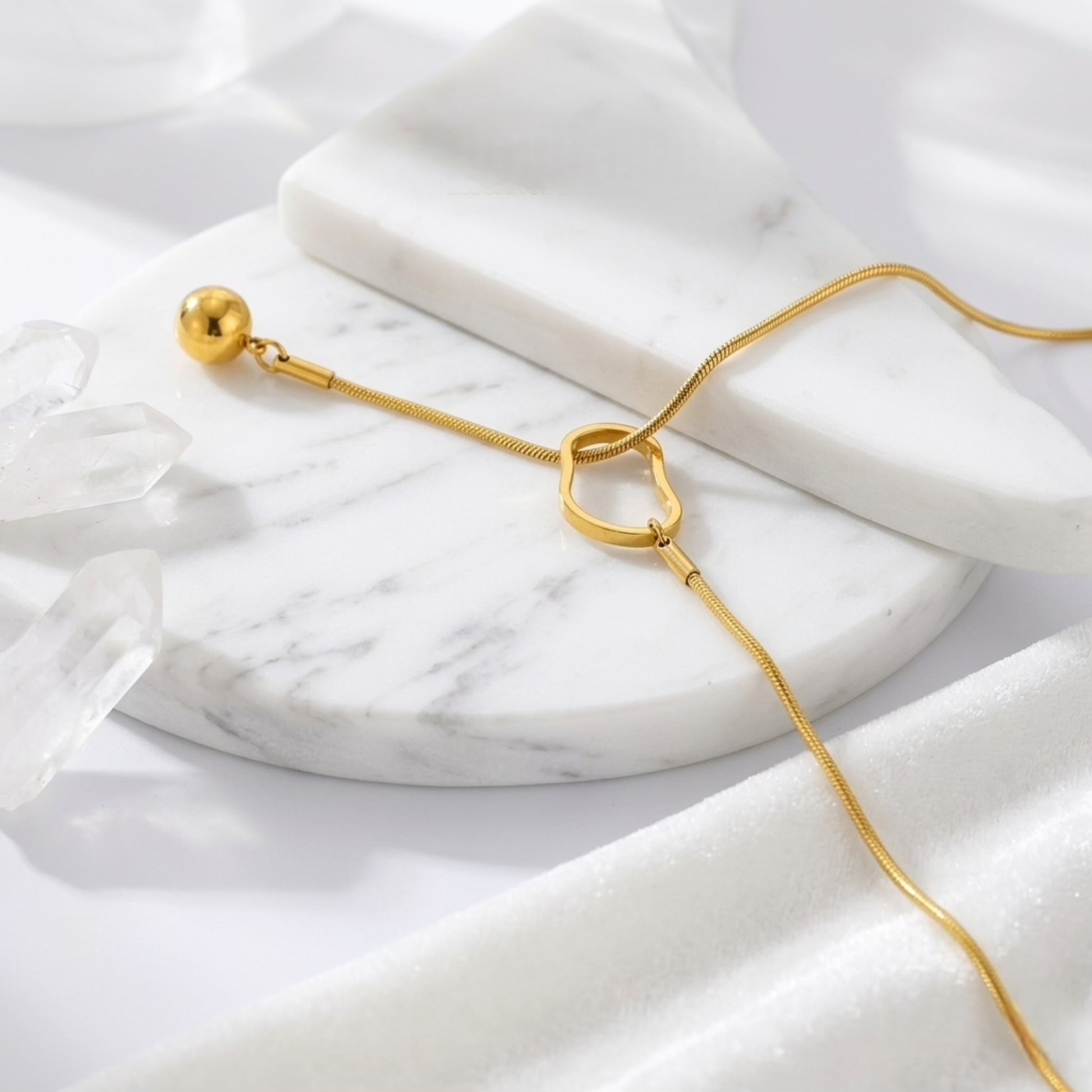 An angled perspective of the BEHI Temwoo Necklace, showcasing the unique oval clasp and high-polish drop pendant.