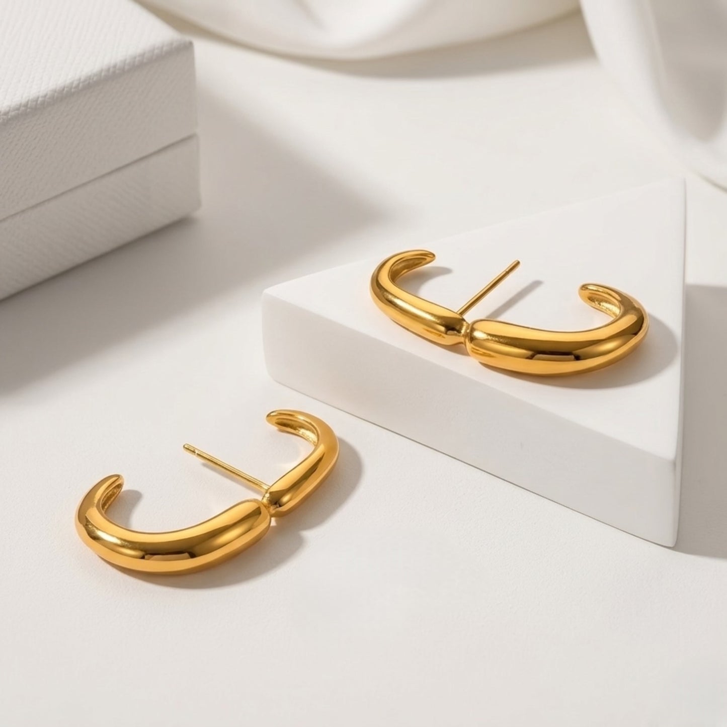 An angled shot of the BEHI Petra Earrings, crafted in hypoallergenic 18k PVD gold-plated steel.