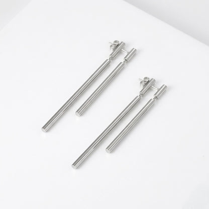 BEHI Deffi Earrings in silver finish, showcasing the sleek, waterproof, and hypoallergenic metallic triple-rod design.