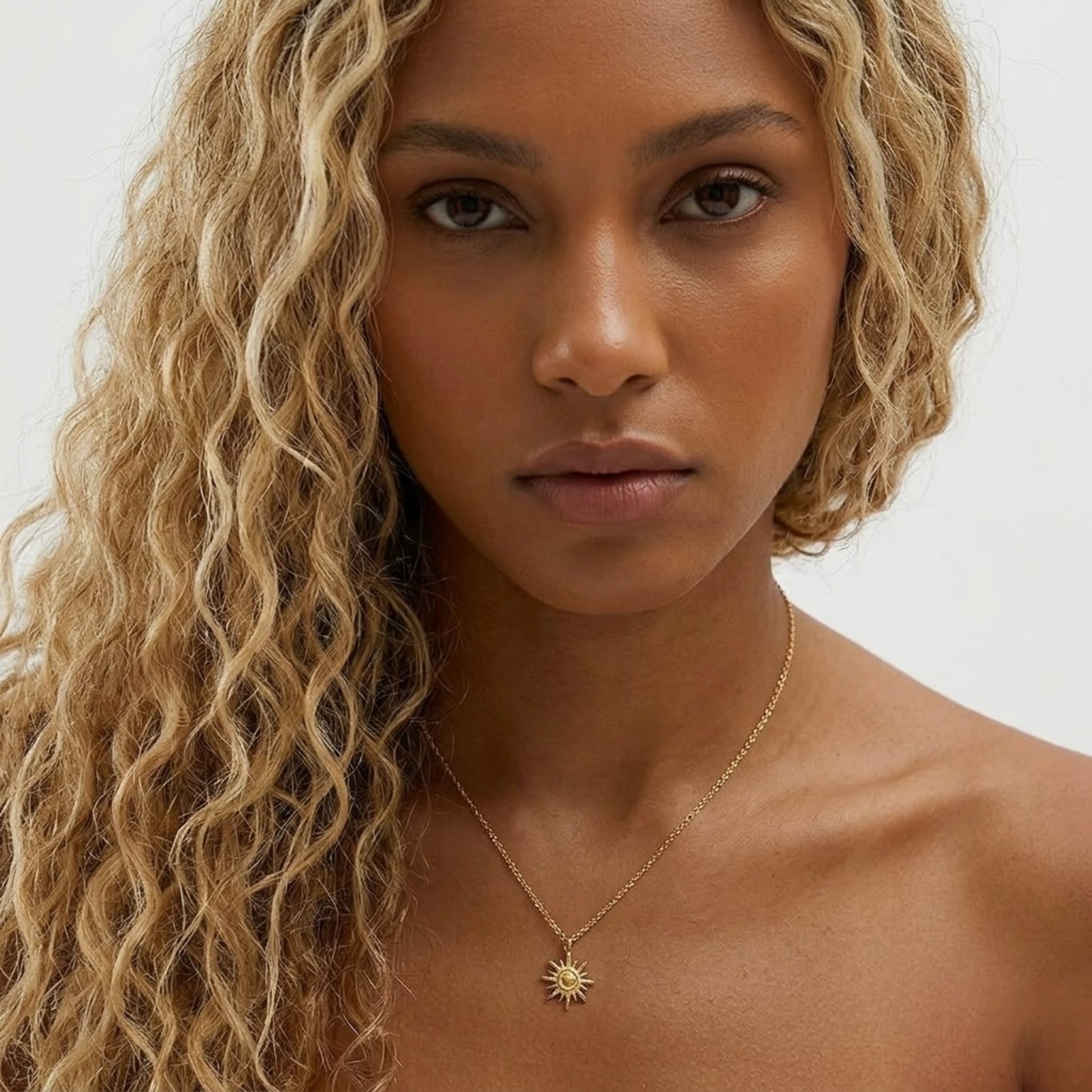 Close-up of the waterproof BEHI LOVE SUN Necklace, highlighting the detailed sculptural rays and polished texture.