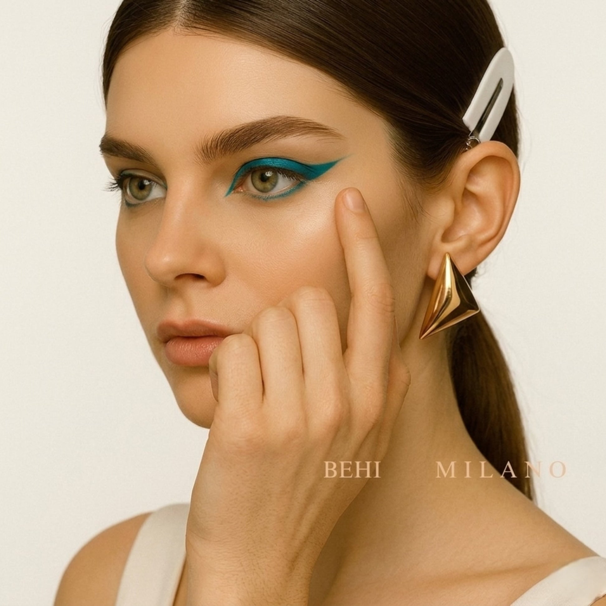 Side view of the waterproof BEHI Santosh Earrings, highlighting the high-polish finish and sculptural edge.