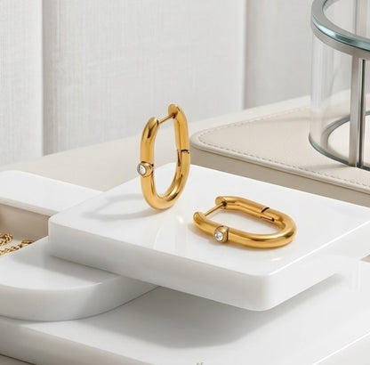 BEHI Eva Earrings | 18k PVD gold-plated stainless steel hoop earrings with a single clear Zircon gemstone set at the center of each hoop | Waterproof, Hypoallergenic and Tarnish-free | Gold finish