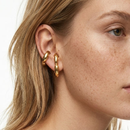 BEHI Petra Earrings worn on the ear to show the hypoallergenic fit and radiant gold finish.