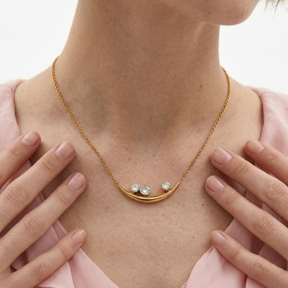 BEHI Rabiya Necklace | 18k PVD gold-plated stainless steel necklace with a crescent-shaped pendant featuring three clear zircon stones set within the curve, attached to a gold chain, minimal design | Waterproof, Hypoallergenic and tarnish-free