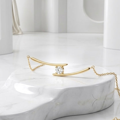 BEHI Alison Necklace on a clean minimalist surface, demonstrating how the gold-plated bar catches the light.
