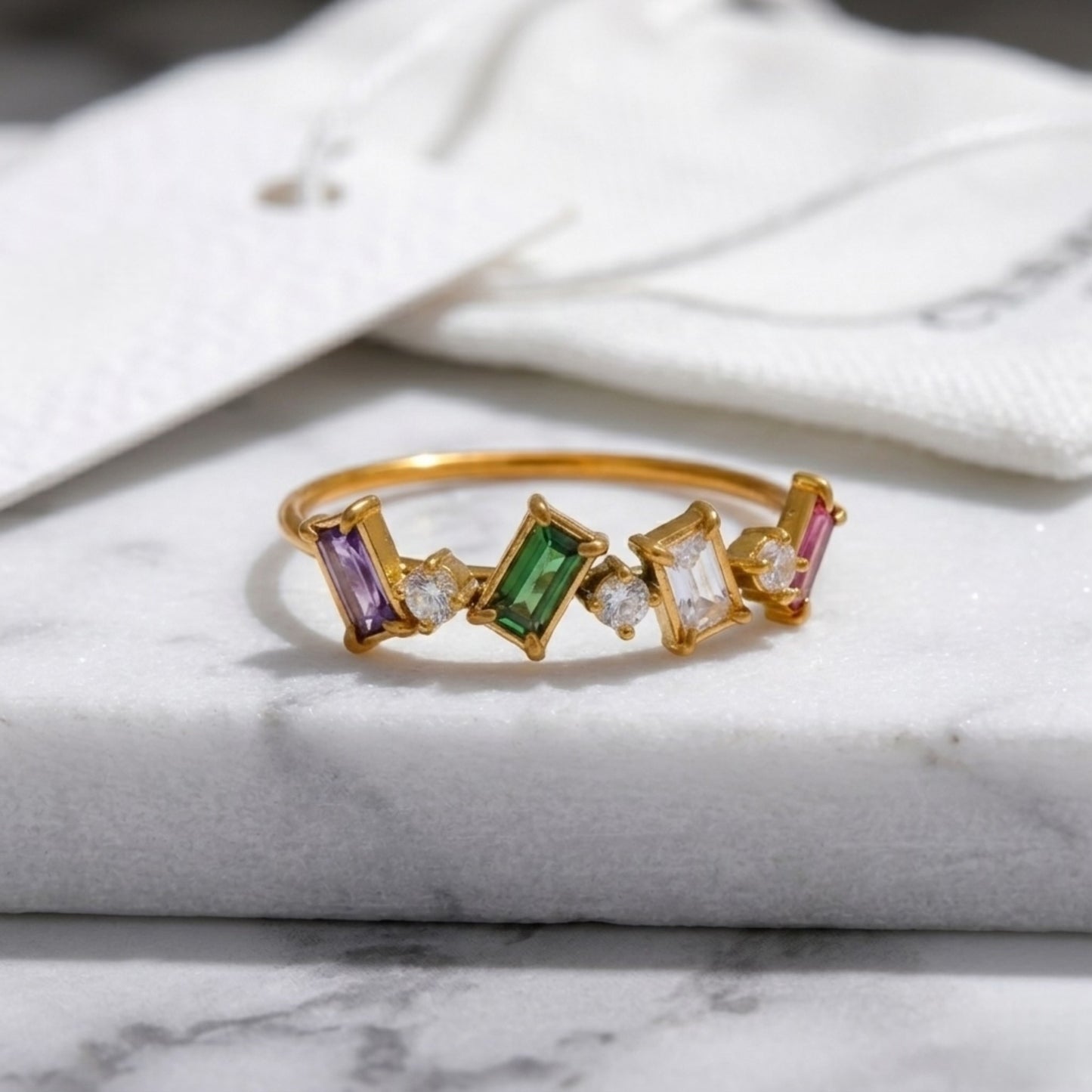 Close-up of the BEHI Melly Ring highlighting the tarnish-resistant and waterproof 18k gold surface, colorful stones.