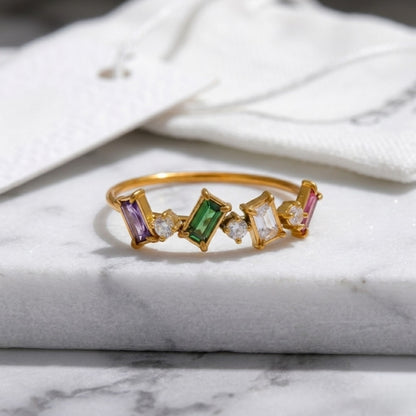 Close-up of the BEHI Melly Ring highlighting the tarnish-resistant and waterproof 18k gold surface, colorful stones.