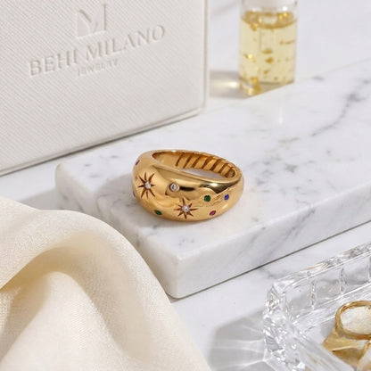 BEHI Camila Ring displayed on a minimal surface, showcasing the high-polish texture of the 18k gold-plated steel.