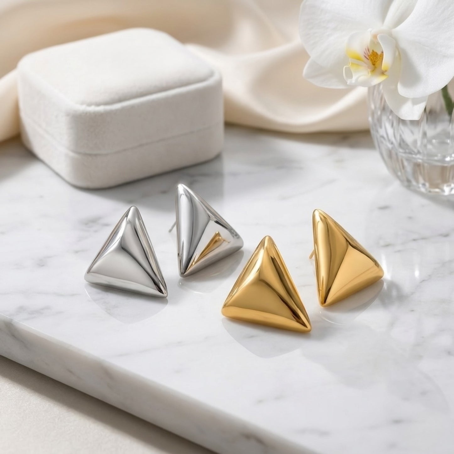 An architectural arrangement of BEHI Santosh Earrings in both gold and silver tarnish-free finishes.