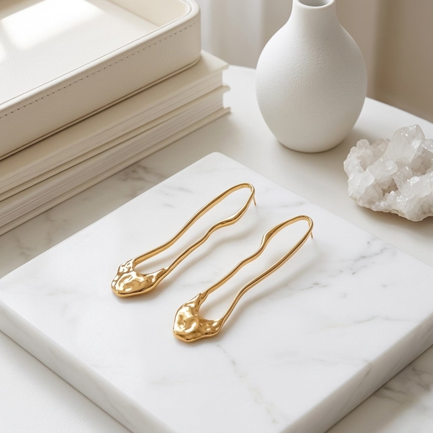 BEHI TRINI 18k PVD gold plated stainless steel earrings with an elongated organic shape in shiny gold finish.