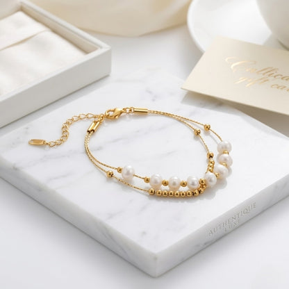 BEHI Tesa Bracelet | 18k PVD gold-plated stainless steel | featuring a string of round natural pearls with gold beads, adjustable chain | Waterproof & Hypoallergenic