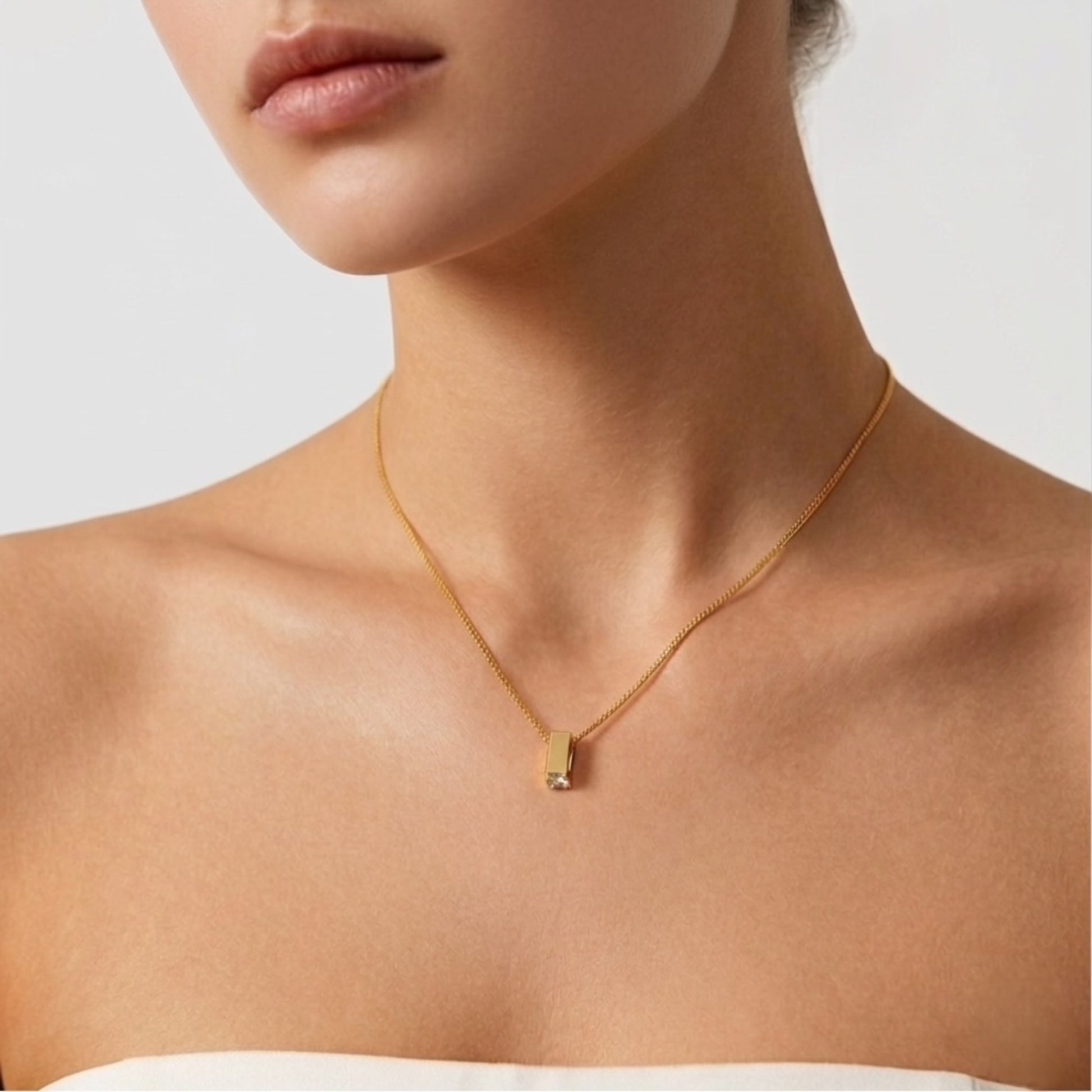 BEHI Zoey Necklace | 18k PVD gold-plated  stainless steel minimal necklace with a rectangular pendant and clear Zircon gemstones at the top and bottom | Waterproof, Hypoallergenic and tarnish-free
