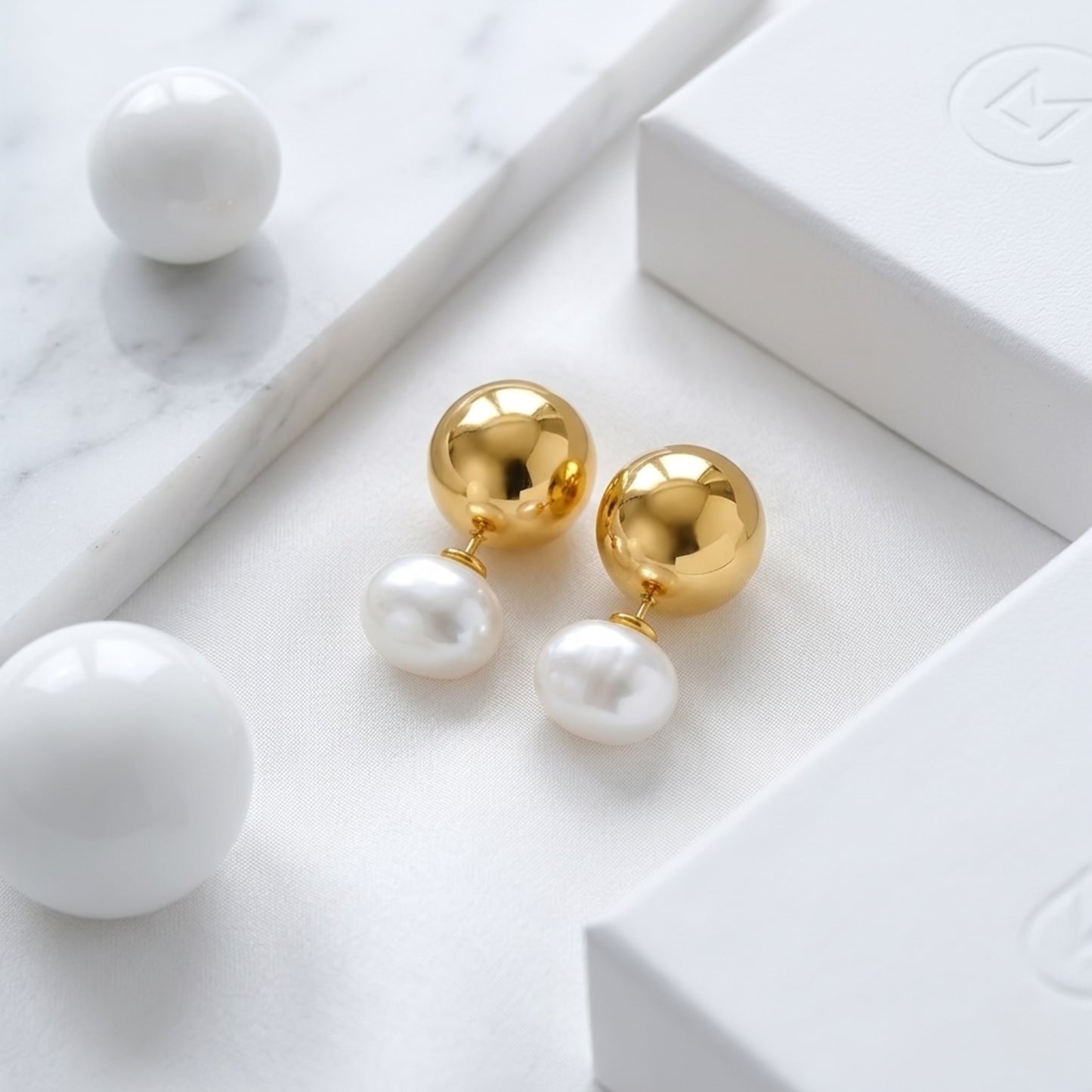 BEHI ROWA earrings featuring a 18k PVD gold plated small sphere with an imitation pearl piece
