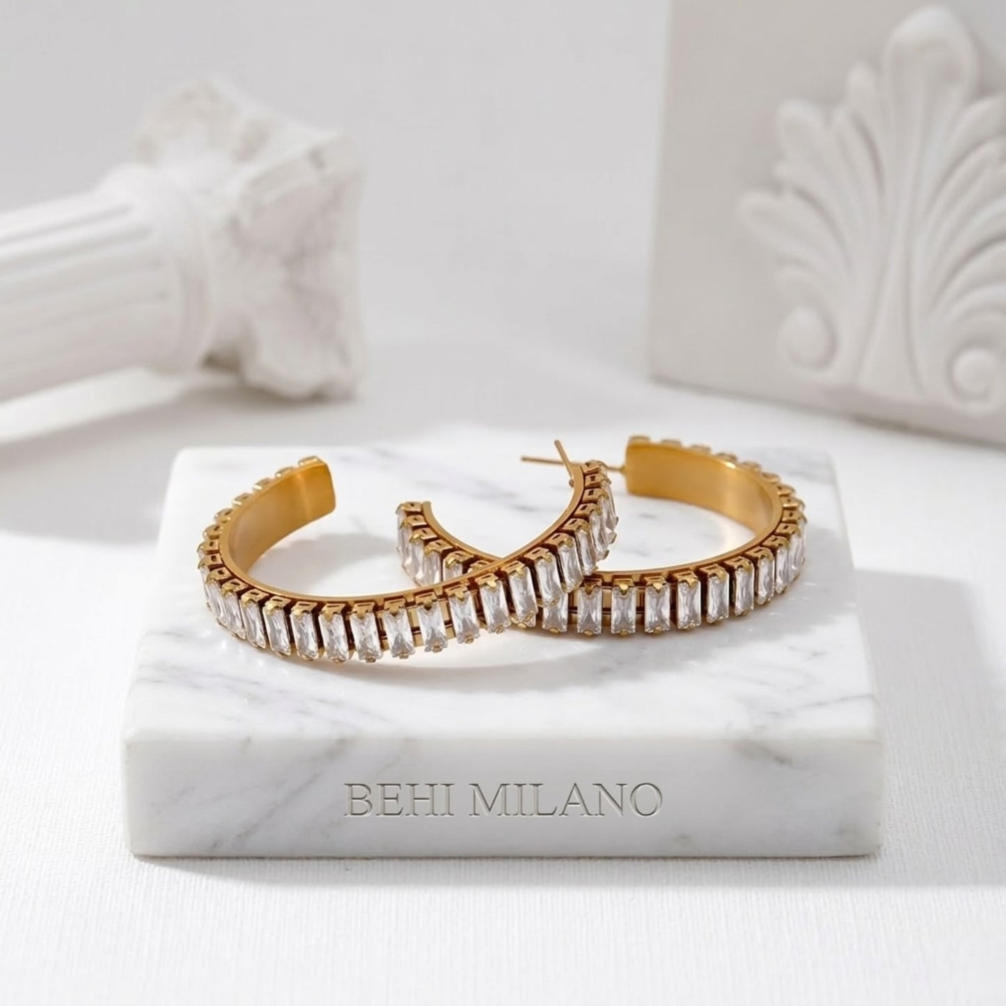 BEHI RIENA 18k PVD gold-plated hypoallergenic stainless steel hoop earrings with multiple rows of Zircon gemstones set in a solid pattern, designed to be worn on the earlobes.