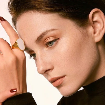 BEHI MARLEN 18k gold plated stainless steel ring with a white marble resin centerpiece.