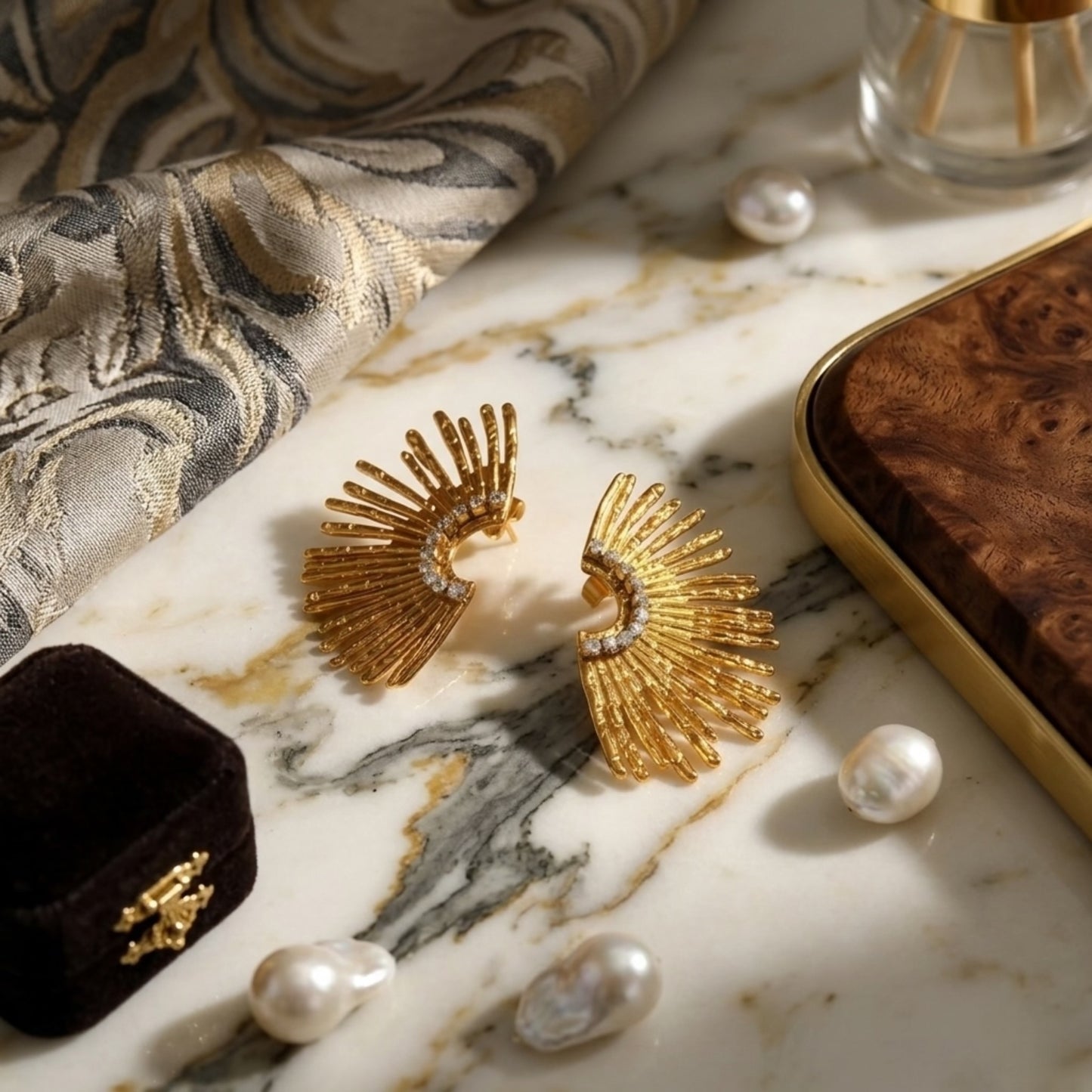 Close-up of the BEHI Indigamond Earrings emphasizing the crystal-embellished spine and polished gold finish.
