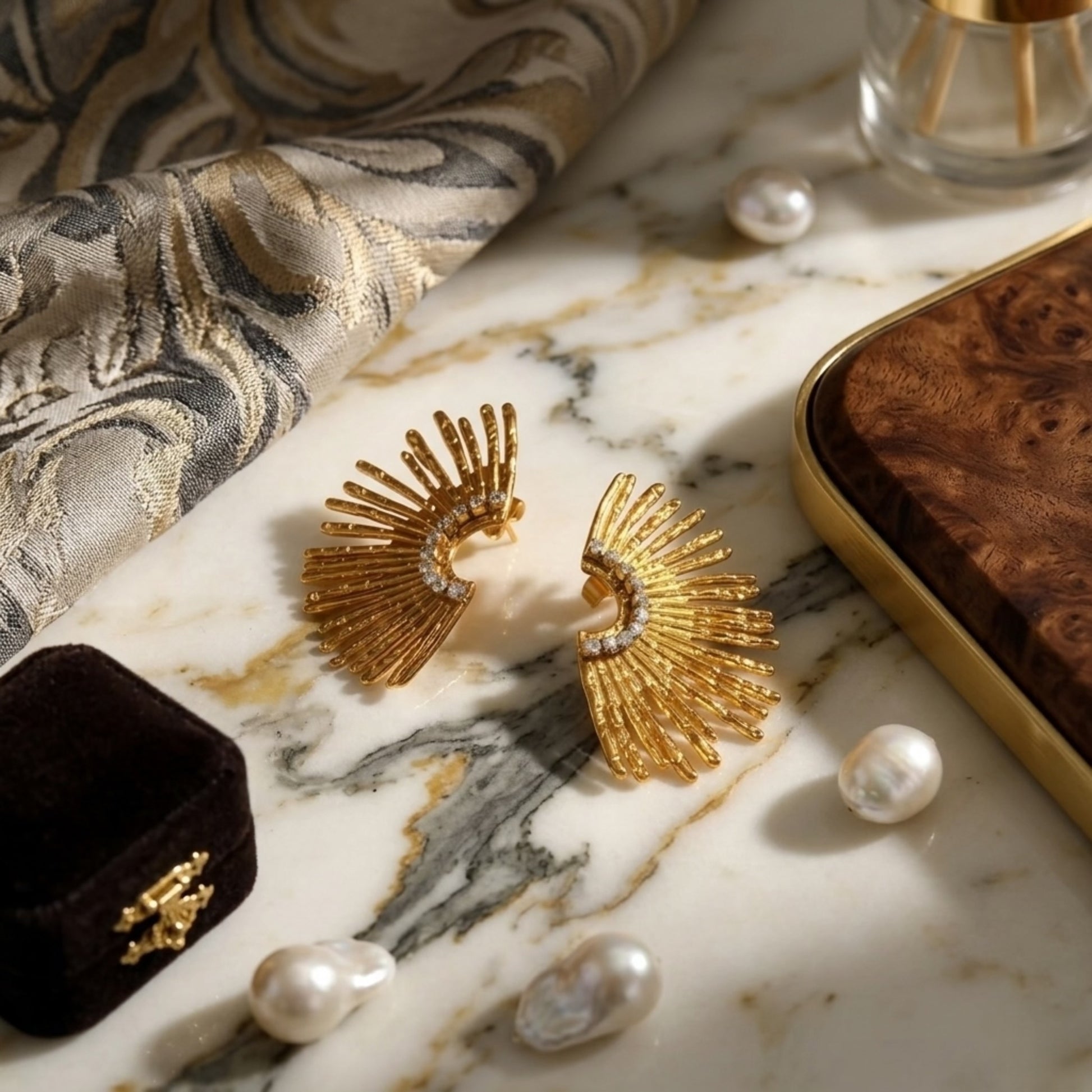Close-up of the BEHI Indigamond Earrings emphasizing the crystal-embellished spine and polished gold finish.