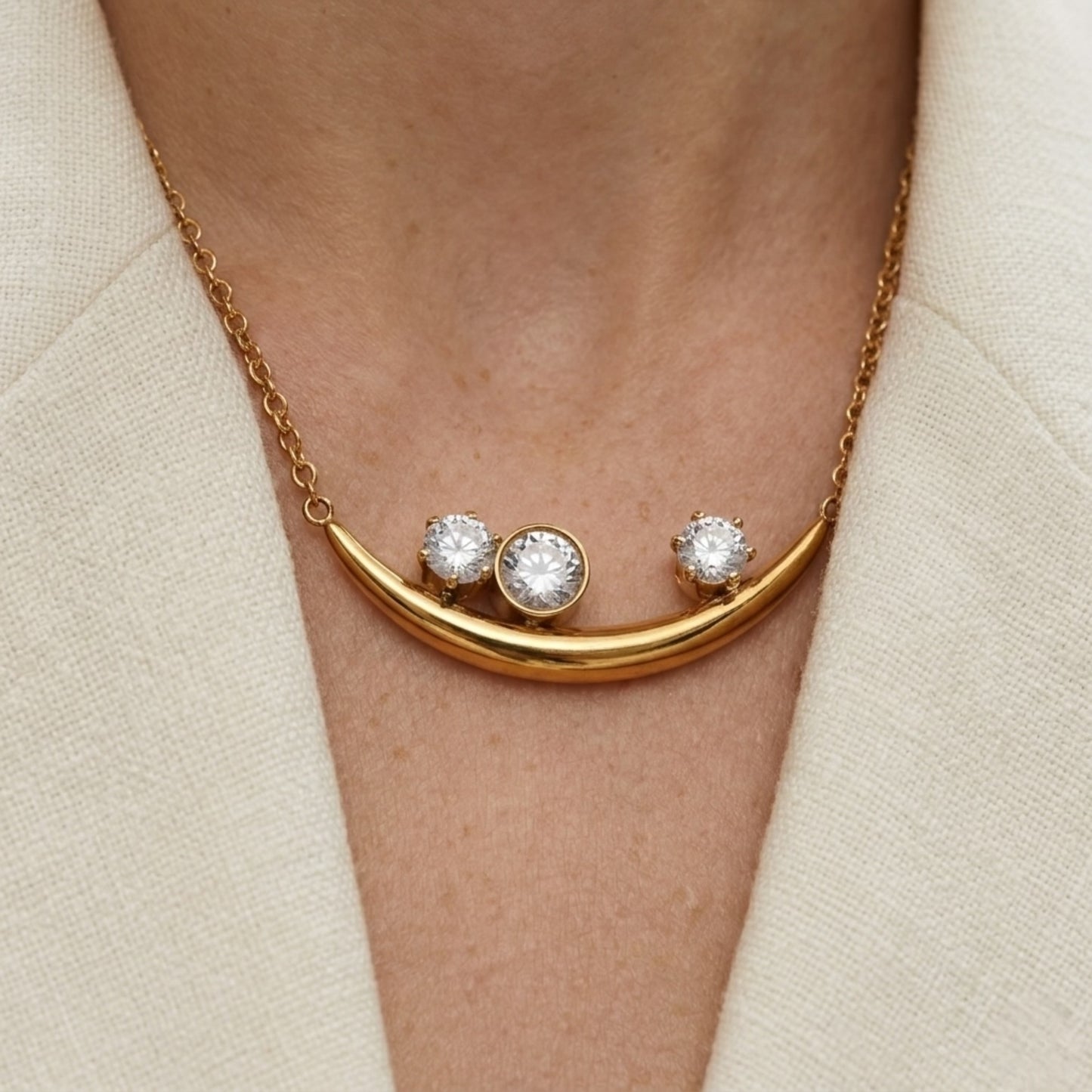 BEHI Rabiya Necklace | 18k PVD gold plated stainless steel necklace with a crescent-shaped pendant featuring three clear zircon stones set within the curve, attached to a gold chain | Waterproof, Hypoallergenic and tarnish-free