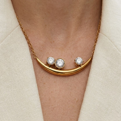 BEHI Rabiya Necklace | 18k PVD gold plated stainless steel necklace with a crescent-shaped pendant featuring three clear zircon stones set within the curve, attached to a gold chain | Waterproof, Hypoallergenic and tarnish-free