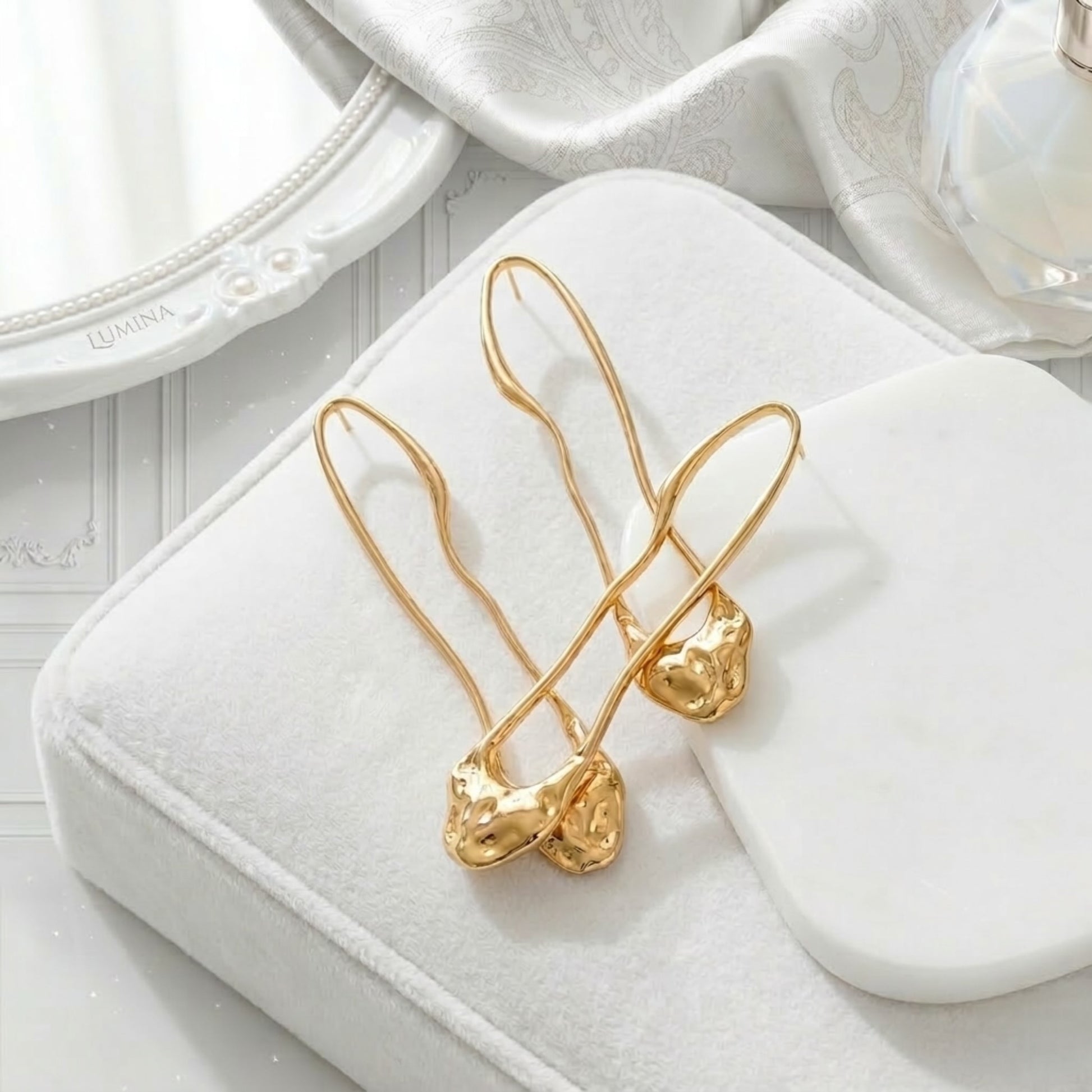 BEHI TRINI 18k PVD gold-plated stainless steel earrings with an elongated organic shape Italian design in shiny gold finish.