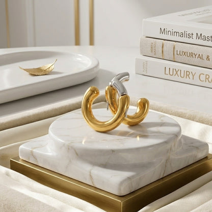 The BEHI Dafne Earrings displayed on a pedestal, showing the durable and tarnish-free mixed-metal finish.