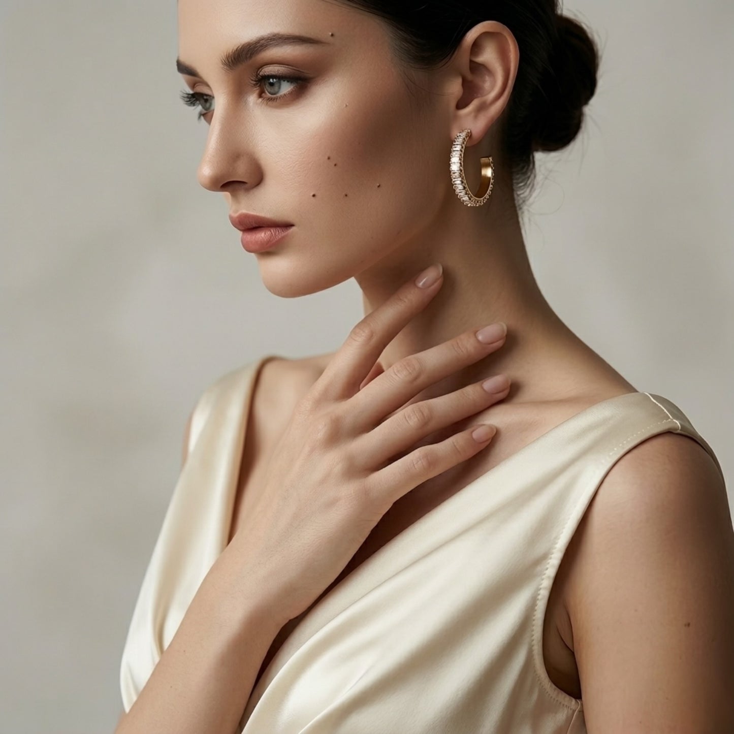 BEHI RIENA 18k PVD gold-plated hypoallergenic stainless steel hoop earrings with multiple rows of white Zircon gemstones set in a solid pattern, designed to be worn on the earlobes.