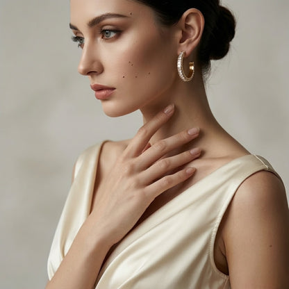 BEHI RIENA 18k PVD gold-plated hypoallergenic stainless steel hoop earrings with multiple rows of white Zircon gemstones set in a solid pattern, designed to be worn on the earlobes.