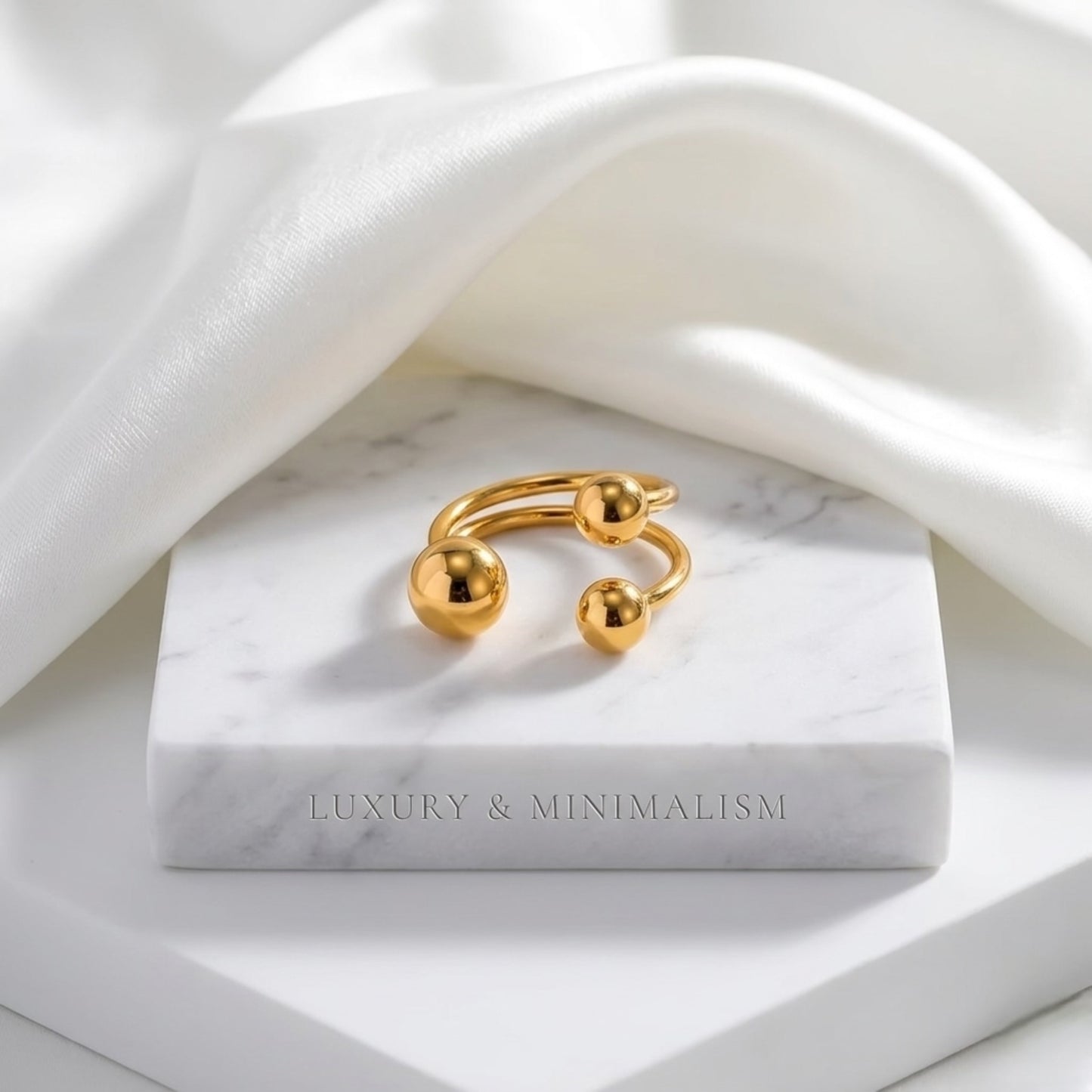 BEHI Mia Bta Ring displayed on a minimal surface, emphasizing the durable and waterproof 18k PVD gold plating.