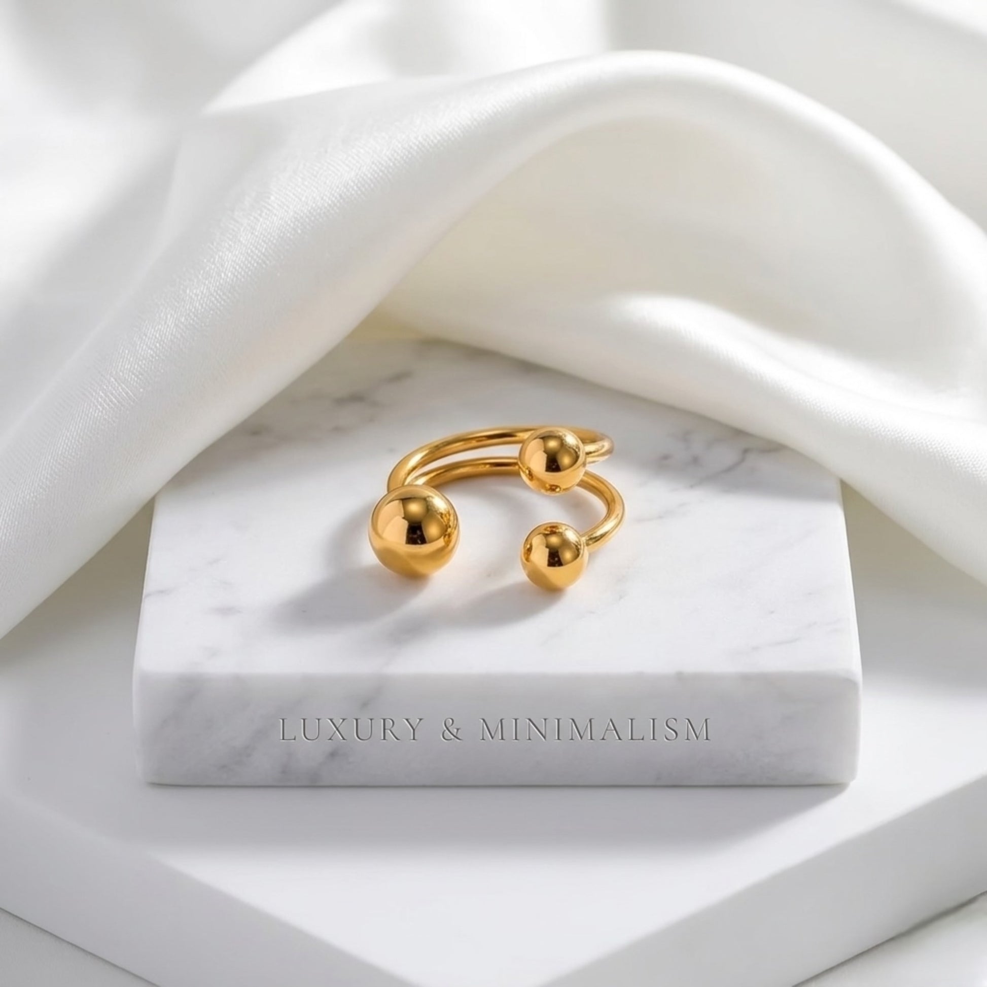 BEHI Mia Bta Ring displayed on a minimal surface, emphasizing the durable and waterproof 18k PVD gold plating.
