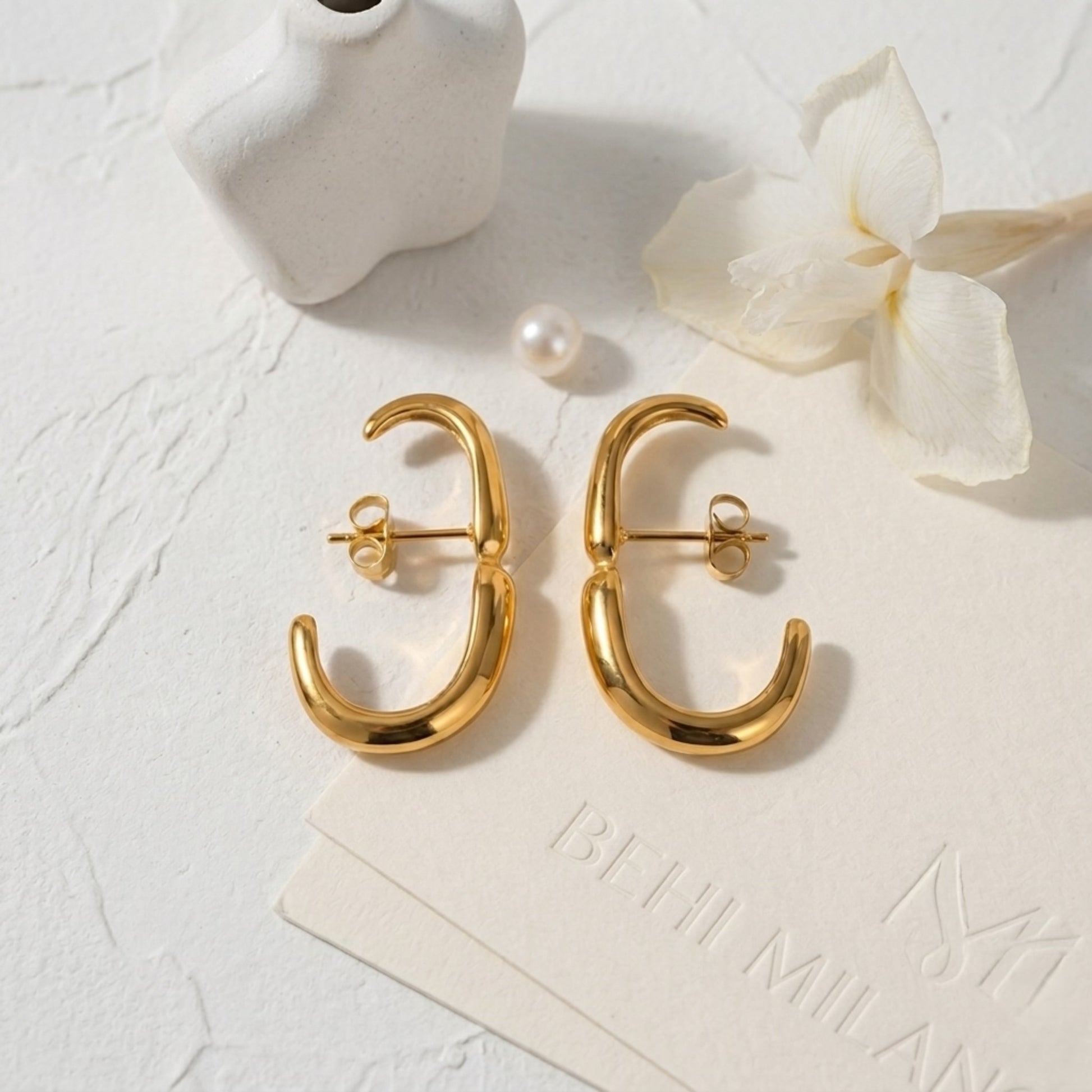 The BEHI Petra Earrings on a minimal background, highlighting the durable, waterproof gold surface.