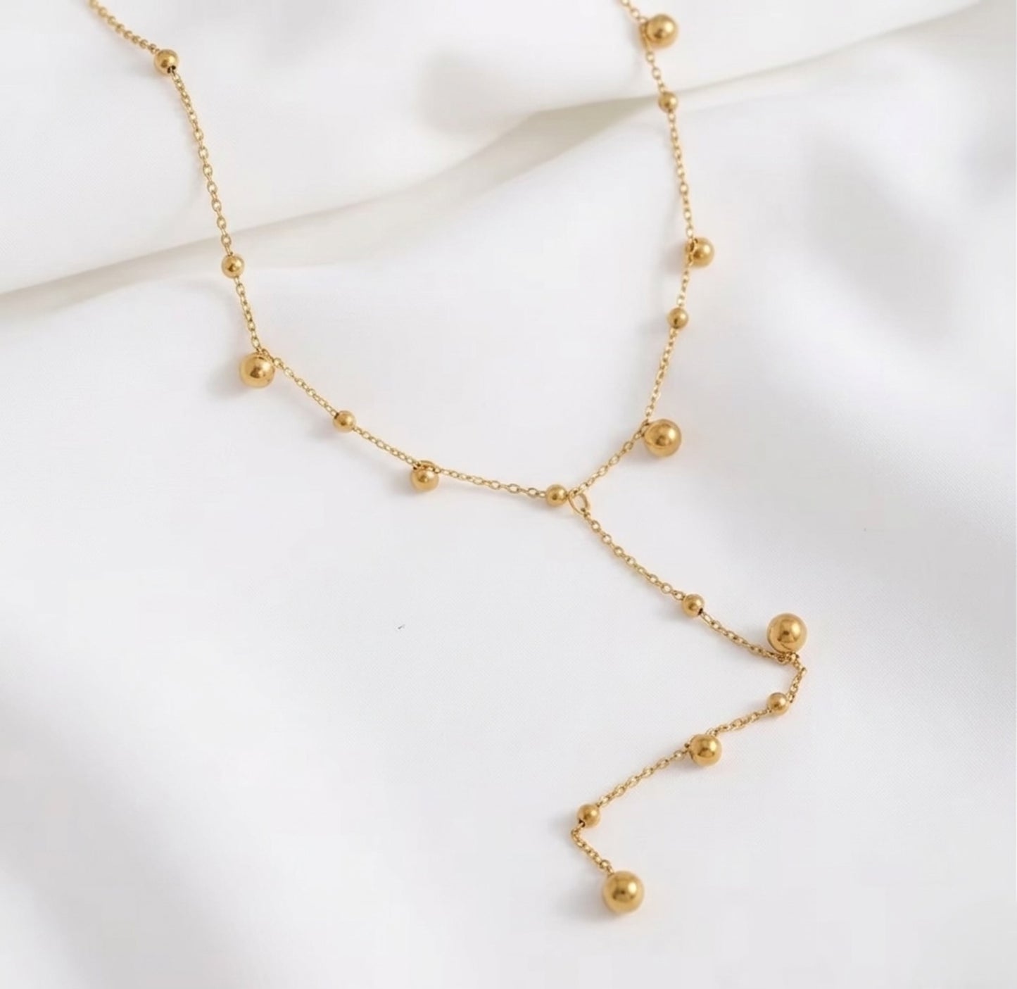 An angled perspective of the BEHI Rovena Necklace, showcasing the durable, high-shine 18k PVD gold plating.