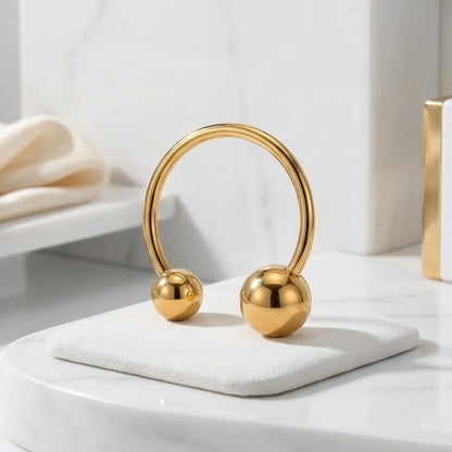 Close-up detail of BEHI MILANO Adriana Ring — polished gold sphere ends on open stainless steel band, 18k PVD coating waterproof jewelry