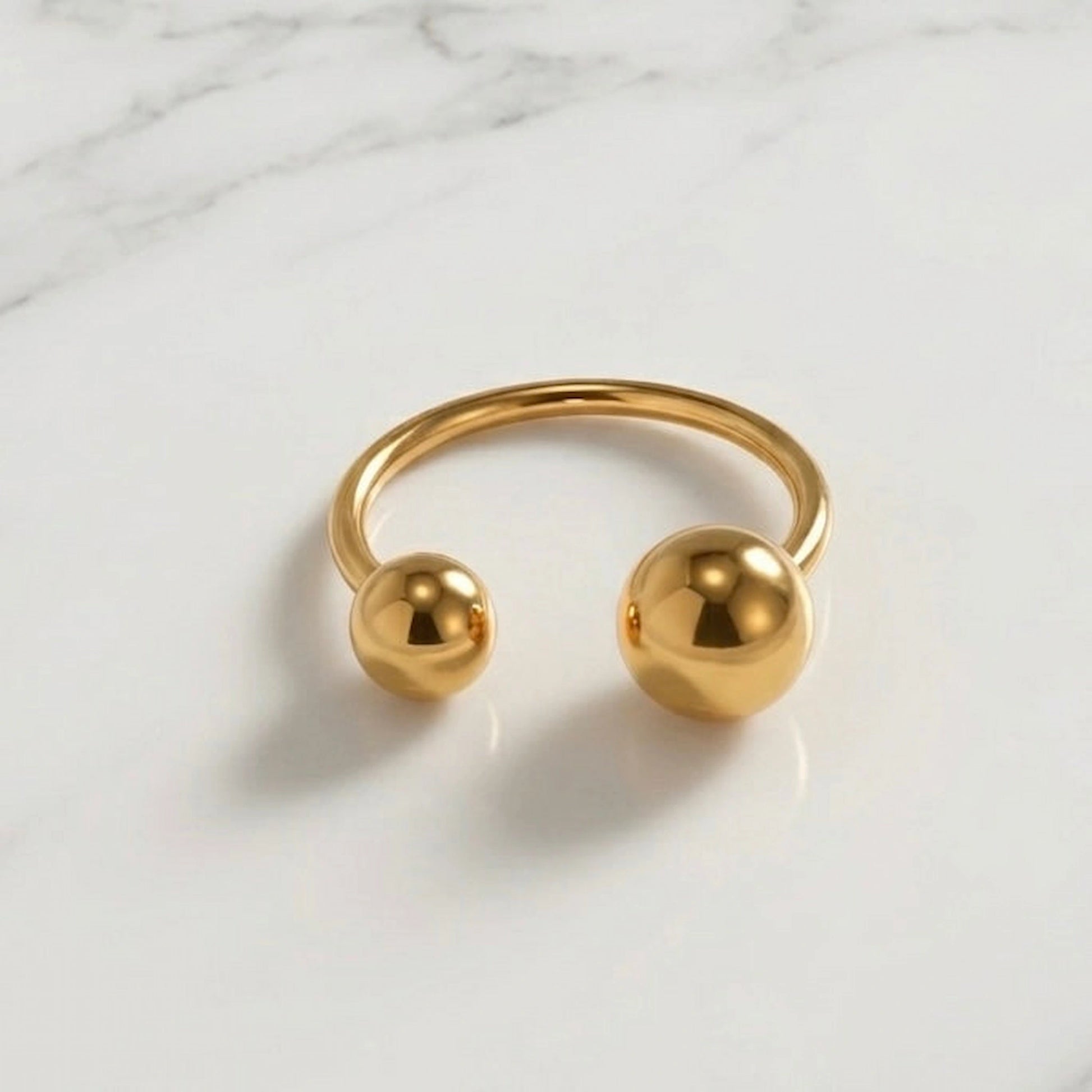 BEHI MILANO Adriana Ring flat lay — minimalist 18k gold-plated open ring with dual sphere ends, waterproof tarnish-free fine jewelry