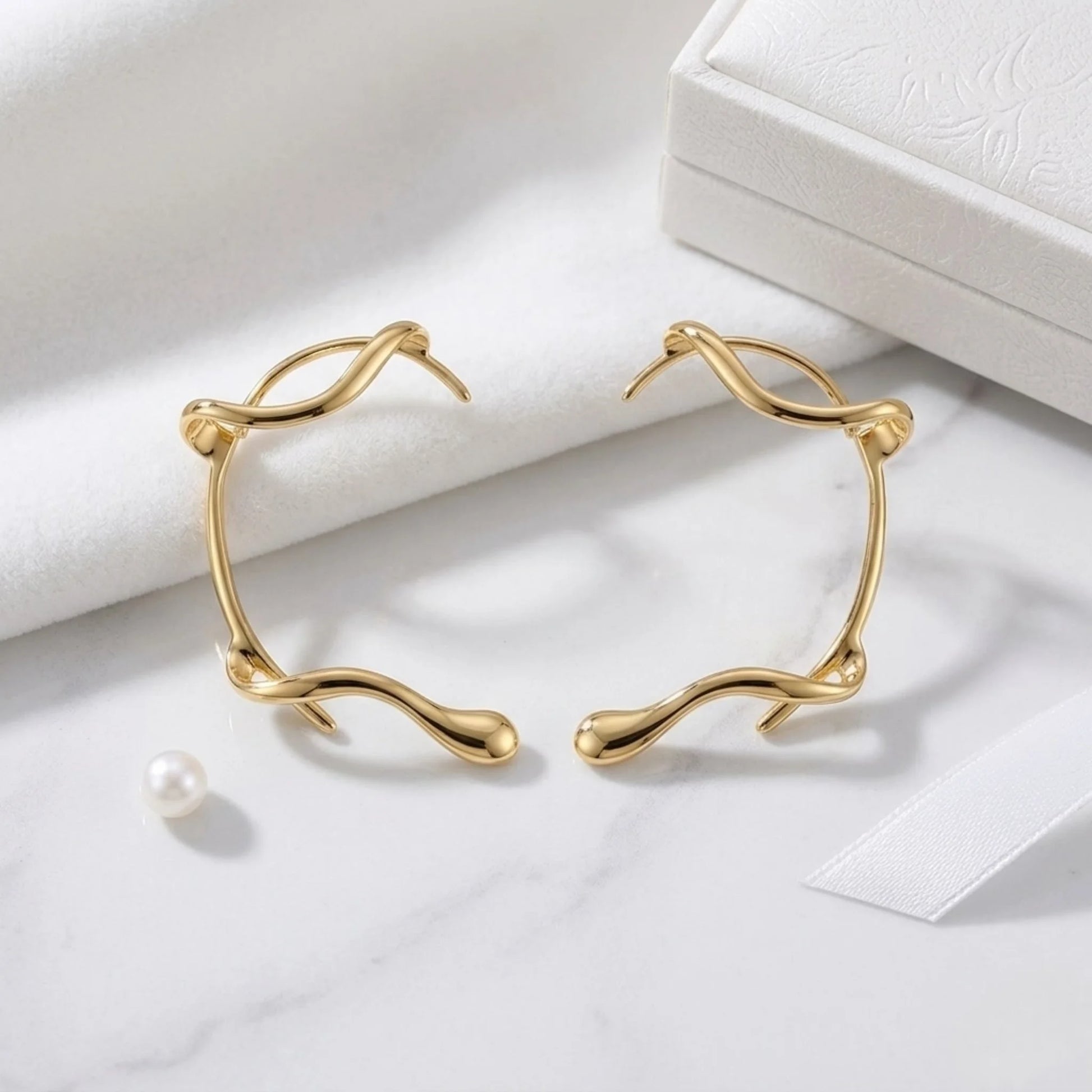 Close-up detail BEHI MILANO Afrodite Ear Cuffs — sculptural gold wrap shape, PVD-coated brass, hypoallergenic tarnish-free earring