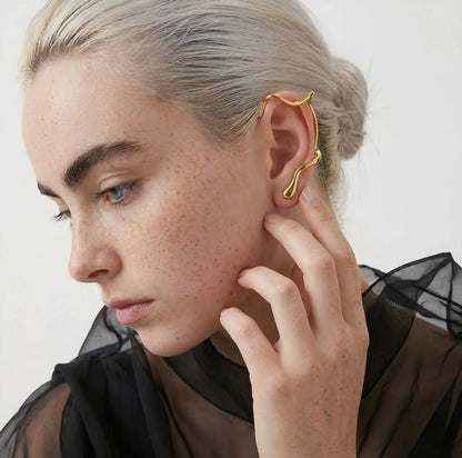 BEHI MILANO Afrodite Ear Cuffs close-up on model — gold wrap-around cuff earring on ear, no piercing required, hypoallergenic jewelry