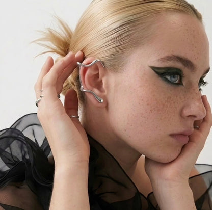 BEHI MILANO Afrodite Ear Cuffs editorial styled shot — silver sculptural wrap ear cuff on model, 18k gold-plated brass, designed in Milan