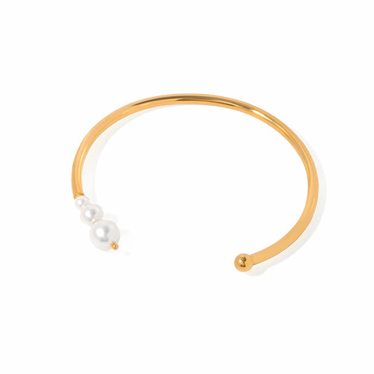 BEHI MILANO Alba Bracelet — 18k gold-plated open cuff bangle with graduated pearl cluster, waterproof tarnish-free stainless steel, white background