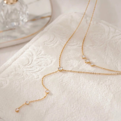 BEHI MILANO Alda Necklace flat lay — double-layer 18k gold lariat with zircon stones and Y-drop chain, tarnish-free waterproof necklace