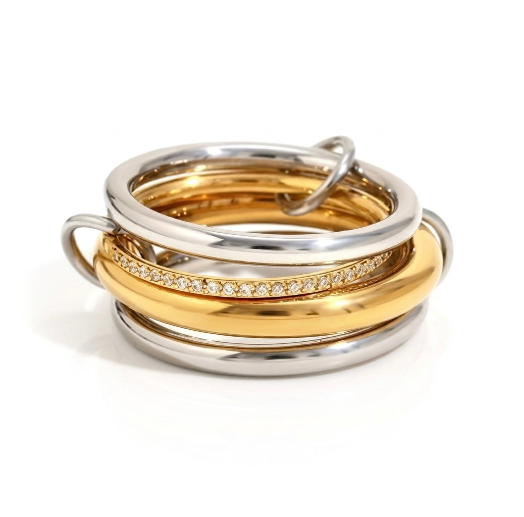 BEHI MILANO Alina Ring — sculptural linked multi-band ring in mixed 18k gold and silver with zircon pavé centre band, waterproof stainless steel