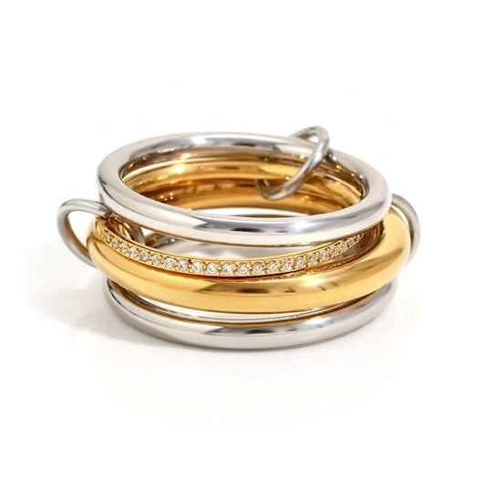 BEHI MILANO Alina Ring — sculptural linked multi-band ring in mixed 18k gold and silver with zircon pavé centre band, waterproof stainless steel