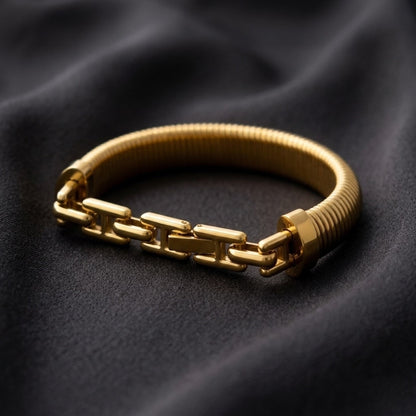 BEHI MILANO Almond Bracelet gold dark background — wide ribbed 18k gold-plated bangle, statement stainless steel jewelry designed in Milan