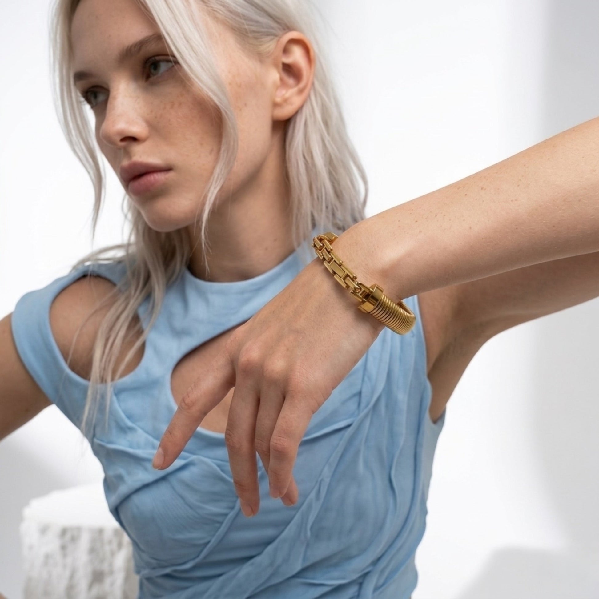 BEHI MILANO Almond Bracelet on model — polished gold wide bangle, waterproof hypoallergenic 18k gold-plated stainless steel jewelry