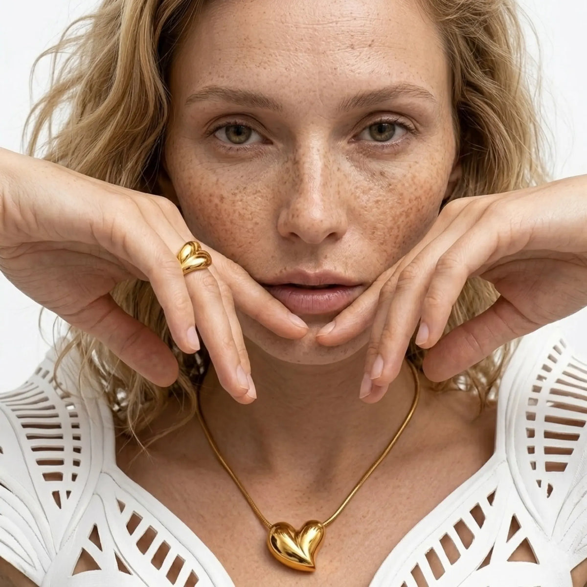 BEHI MILANO Amorino Necklace — close-up view of gold heart pendant necklace on model