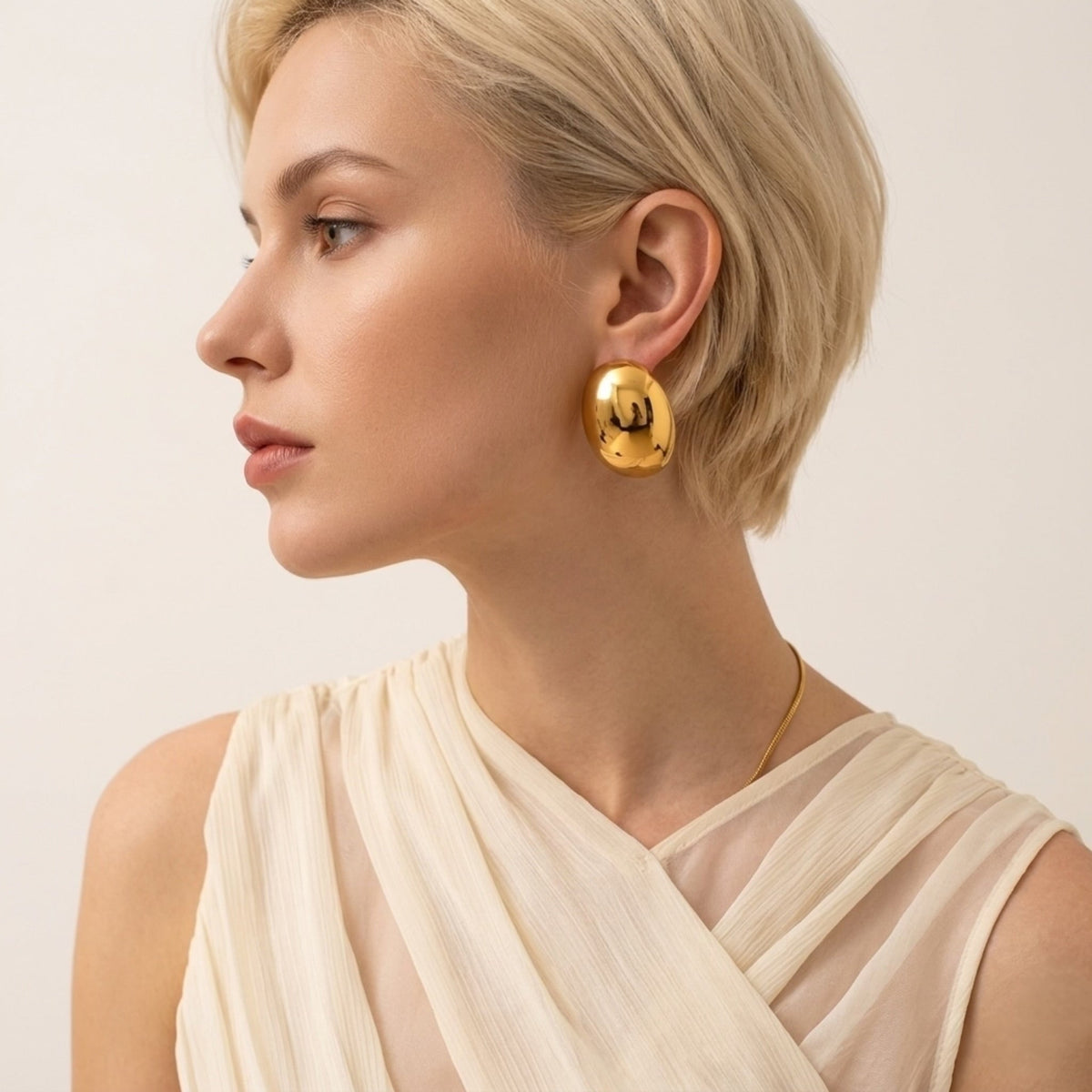 BEHI MILANO Annarita Earrings — model side profile wearing gold chunky oval dome studs