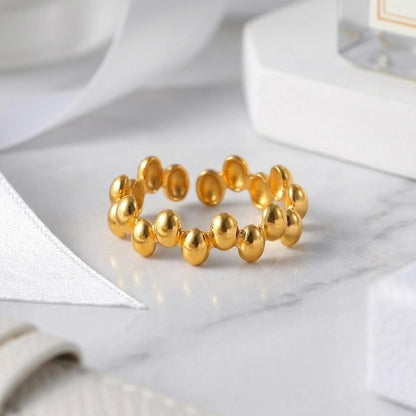 BEHI MILANO Anya Ring — detailed view of gold beaded texture on marble surface